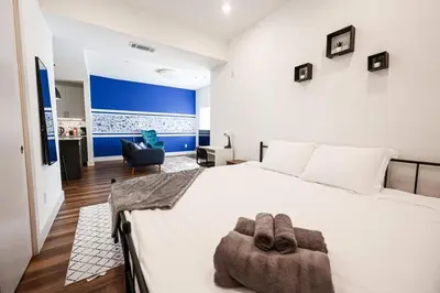 a bedroom with a large white bed with two towels on it at Modern 1BD AptWiFi,Gym,Washer in Philadelphia