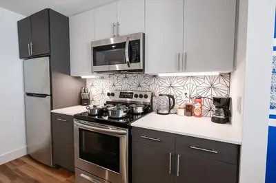 a kitchen with a stove and a microwave at Modern 1BD AptWiFi,Gym,Washer in Philadelphia