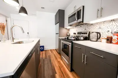 a kitchen with a sink and a stove top oven at Modern 1BD AptWiFi,Gym,Washer in Philadelphia