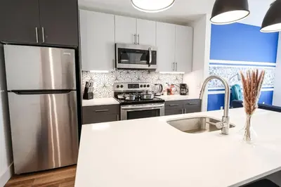a kitchen with a stainless steel refrigerator and a sink at Modern 1BD AptWiFi,Gym,Washer in Philadelphia