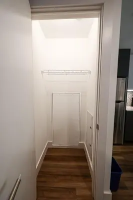 a hallway with a white door and wooden floors at Modern 1BD AptWiFi,Gym,Washer in Philadelphia