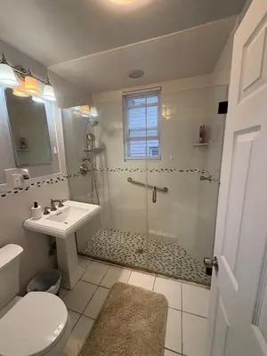 a bathroom with a shower and a toilet and a sink at 4 bedroom apartment by Ewr Airport in Newark