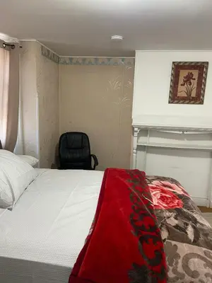 a bedroom with a bed with a red blanket on it at C Jay Homes 6 minutes Walk to Journal square in Jersey City