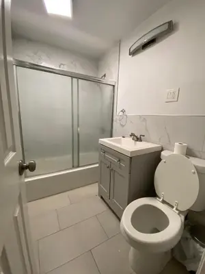 a bathroom with a shower and a toilet and a sink at C Jay Homes 6 minutes Walk to Journal square in Jersey City