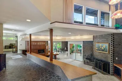 a living room with a fireplace and a dining room at Nature's Retreat 4-Bedroom Cabin in Honesdale