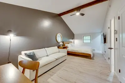a living room with a white couch and a bed at Lake Access at Family-Friendly Home in Tobyhanna in Tobyhanna
