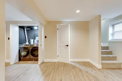 an empty living room with stairs and a door at Lake Access at Family-Friendly Home in Tobyhanna in Tobyhanna