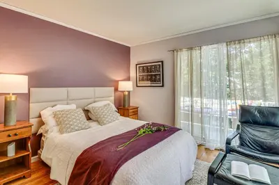 a bedroom with a bed and a chair and a window at 1 Mi to Campus Princeton Home with Furnished Deck in Princeton