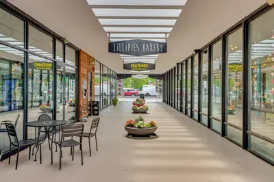 an empty shopping mall with tables and chairs and windows at 1 Mi to Campus Princeton Home with Furnished Deck in Princeton