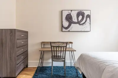 a bedroom with a desk and a chair next to a bed at 5 Bedroom 2 Bath Full Floor Midtown in New York
