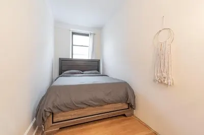 a bedroom with a bed in a white wall at 5 Bedroom 2 Bath Full Floor Midtown in New York