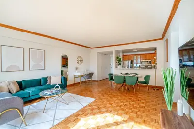 a living room with a blue couch and a table at Contemporary 2 Bed 2 Bath Apt Bright and Sunny in New York