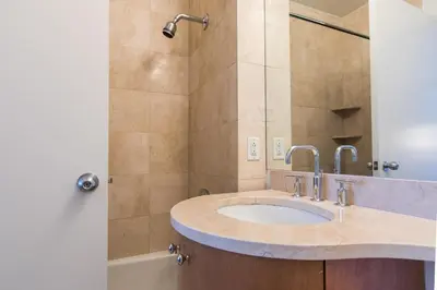 a bathroom with a sink and a shower at Bright 2 Bedrooms 2 Bathrooms Unit in New York