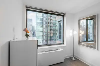 a kitchen with a large window with a city view at Fully Furnished 1BR in Murray Hills in New York