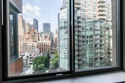 a view of a city skyline from a window at Fully Furnished 1BR in Murray Hills in New York