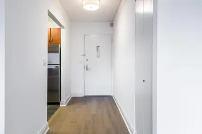a hallway with white walls and a white door at Beautiful 1 Bed Fully Furnished Apartment in New York