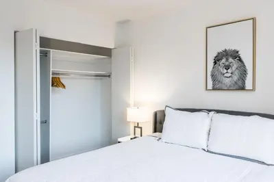 a bedroom with a bed with a lion picture on the wall at Beautiful 1 Bed Fully Furnished Apartment in New York