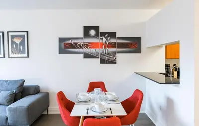 a living room with a table and red chairs at Beautiful 1 Bed Fully Furnished Apartment in New York