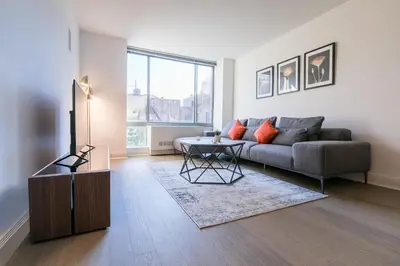 a living room with a couch and a table at Beautiful 1 Bed Fully Furnished Apartment in New York