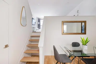 a dining room with a glass table and a mirror at Amazing Apartment for 2 1 Bed 1 Bath in New York