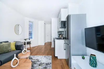 a living room with a couch and a tv at 1 BR Gem in Prime Location of NYC in New York