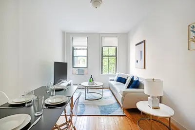 a living room with a couch and a table at Prime Upper west Side Location 1 Bedroom Apt in New York
