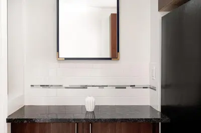 a bathroom counter with a mirror and a sink at Prime Upper west Side Location 1 Bedroom Apt in New York