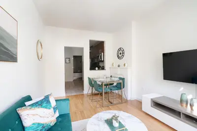 a living room with a couch and a table at Contemporary 1 Bedroom Apartment in NYC in New York