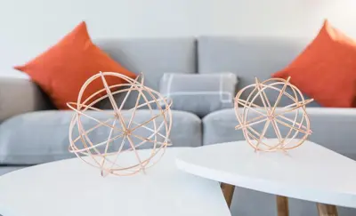 two tables with spheres on them in a living room at Fully Furnished Studio Apartment in New York