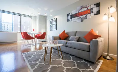 a living room with a couch and a table at Fully Furnished Studio Apartment in New York
