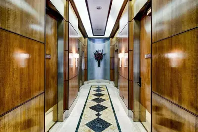 a hallway with wooden walls and a vase of flowers at Fully Furnished Studio Apartment in New York