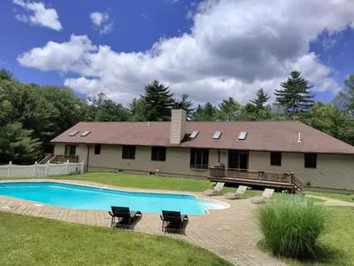 a house with a swimming pool in the yard at Spacious House with a Pool in Glen Spey