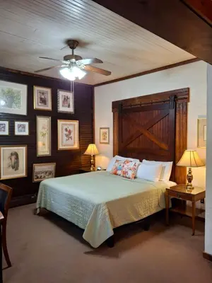 a bedroom with a bed and a ceiling fan at Inn at Lake Joseph in Forestburgh