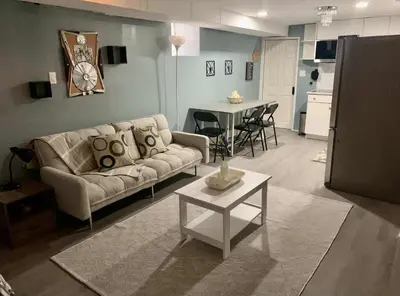 a living room with a couch and a table at Suhira Hospitality in Lansdowne