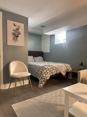 a bedroom with a bed and a chair at Suhira Hospitality in Lansdowne