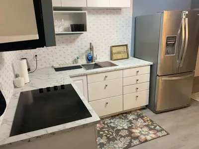 a kitchen with a stove and a refrigerator at Suhira Hospitality in Lansdowne