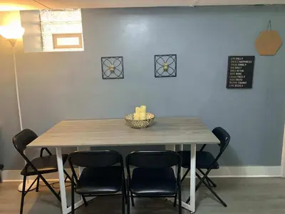 a table with four chairs and a bowl on top at Suhira Hospitality in Lansdowne