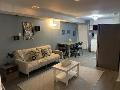 a living room with a couch and a table at Suhira Hospitality in Lansdowne