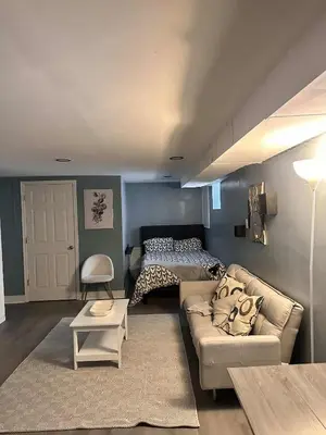 a living room with a couch and a bed at Suhira Hospitality in Lansdowne