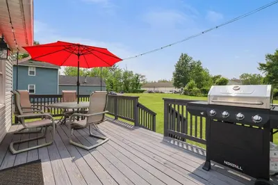 a deck with a grill and a table with chairs at Remodeled 4BR w Yard, Fire Pit, Near Camelback in Tannersville