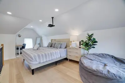 a bedroom with a bed and a dresser in it at Remodeled 4BR w Yard, Fire Pit, Near Camelback in Tannersville