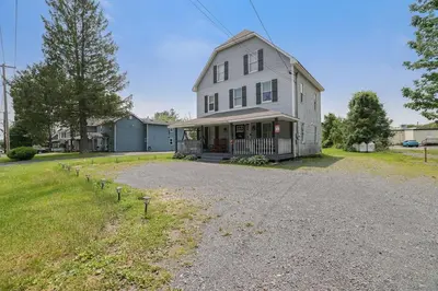 a large white house with a gravel driveway at Remodeled 4BR w Yard, Fire Pit, Near Camelback in Tannersville