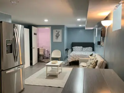 a kitchen and living room with a refrigerator and a bed at Suhira Hospitality Group in Lansdowne