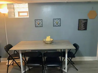 a dining room table with chairs and a bowl on it at Suhira Hospitality Group in Lansdowne