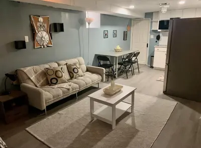 a living room with a couch and a table at Suhira Hospitality Group in Lansdowne