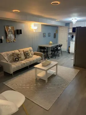 a living room with a couch and a table at Suhira Hospitality Group in Lansdowne
