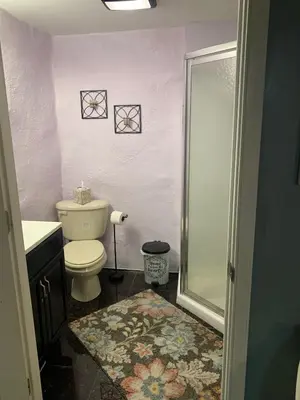 a small bathroom with a toilet and a shower at Suhira Hospitality Group in Lansdowne