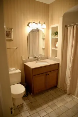 a bathroom with a sink and a toilet and a mirror at Strasburg Village Inn in Strasburg