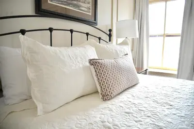 a bedroom with a bed with white pillows at Strasburg Village Inn in Strasburg