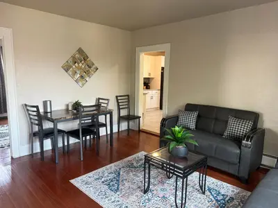 a living room with a couch and a table at Judees' Comfort 3 in Newark